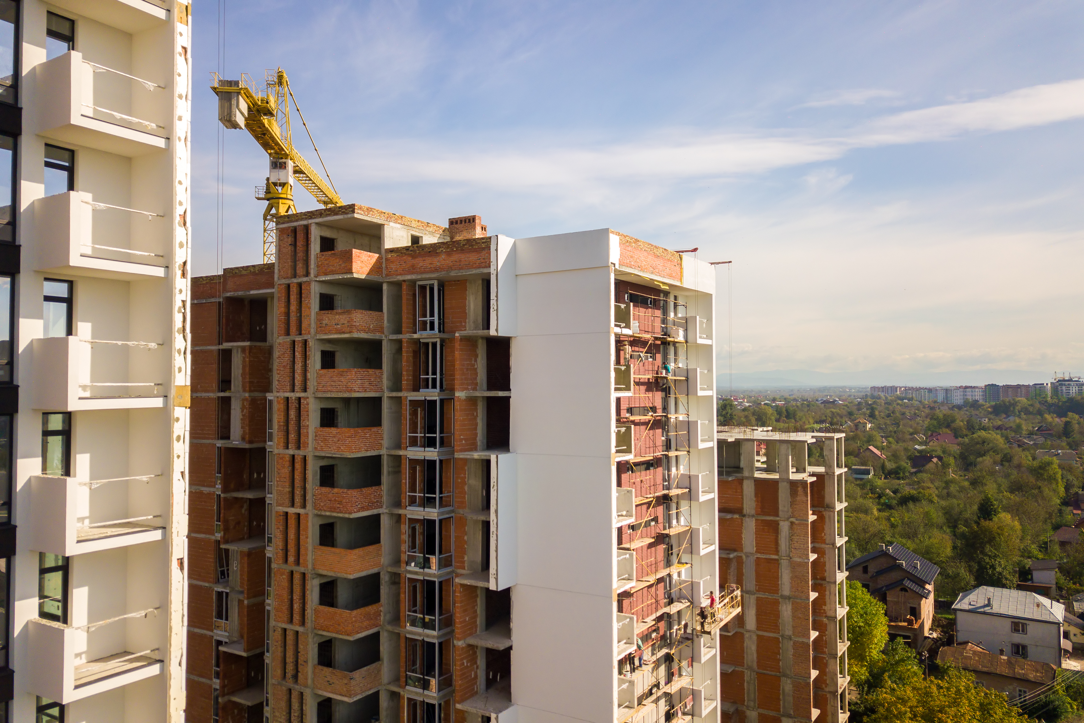 Aerial view of multi storey residential apartment buildings under construction. Real estate development.