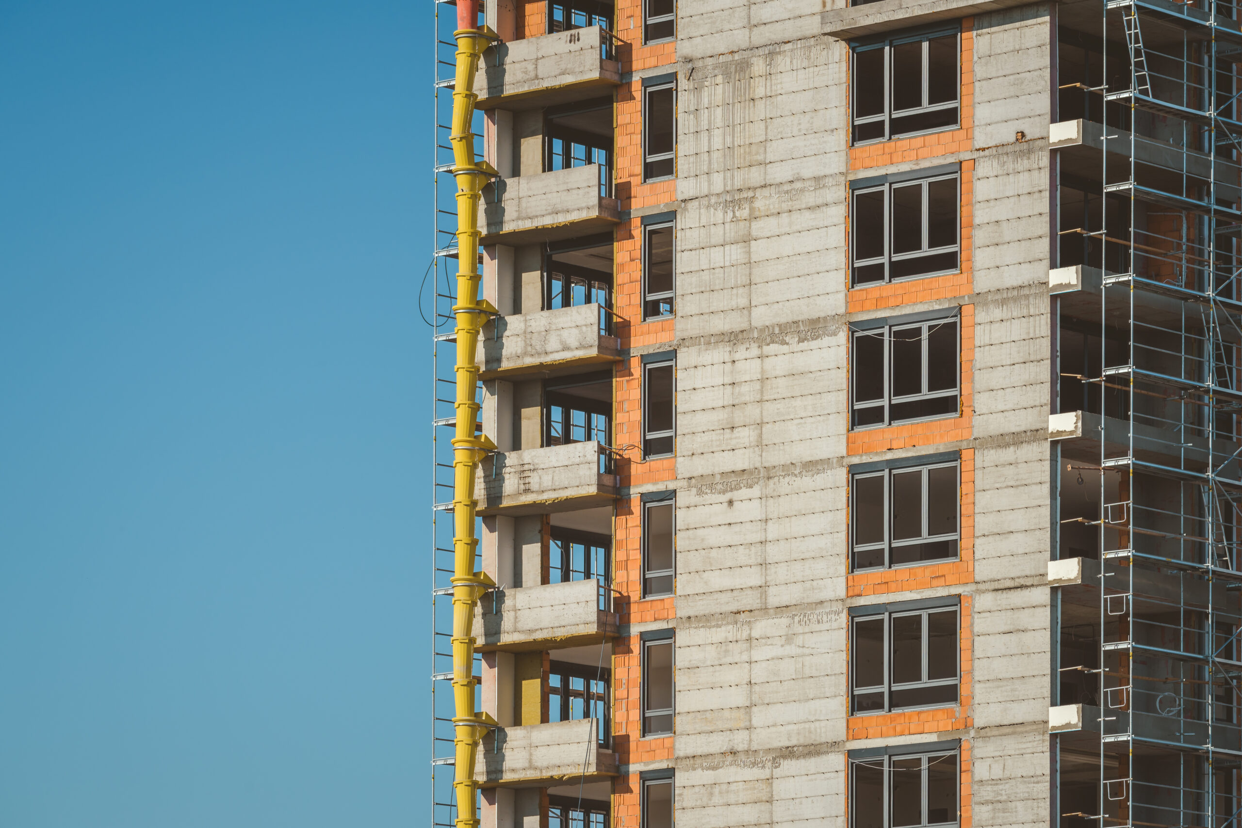 High-rise skyscraper building under construction with sky as copy space